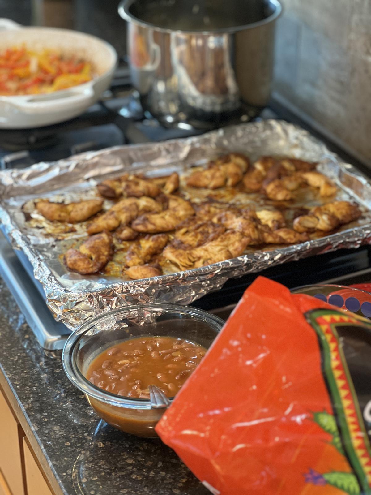 chicken beans chips and peppers on the stove top