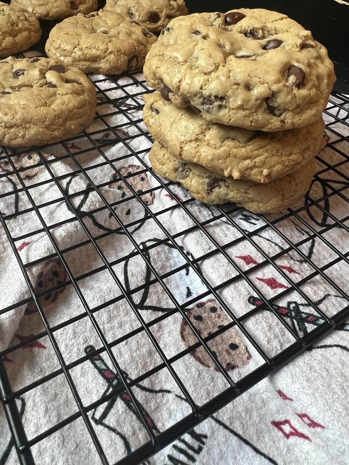 a stack of chocolate chip cookies on cooling rack