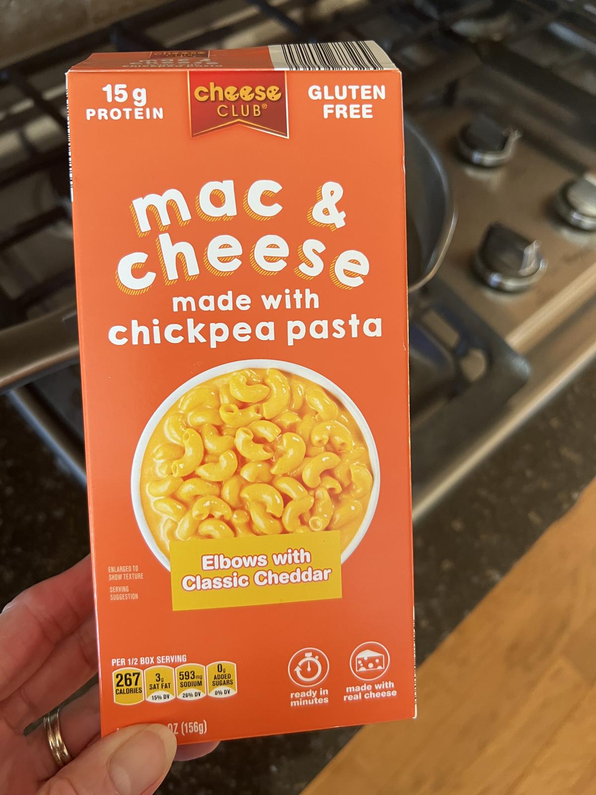 hand holding box of Aldi chickpea mac and cheese