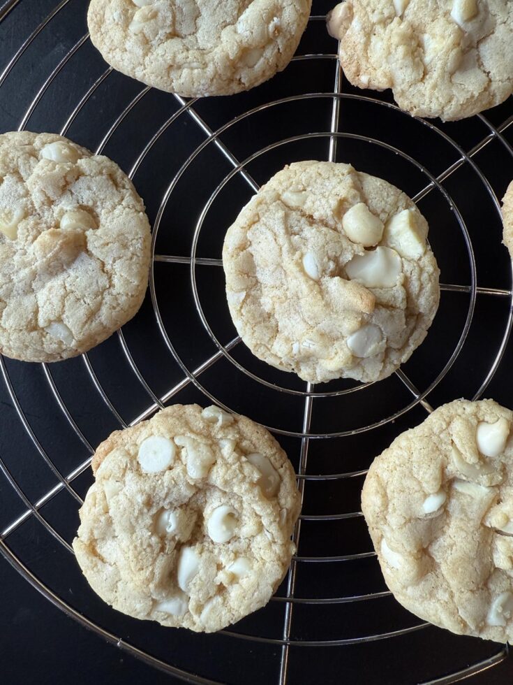 close up of gluten free white chocolate macadamia nut cookie on cooling rack