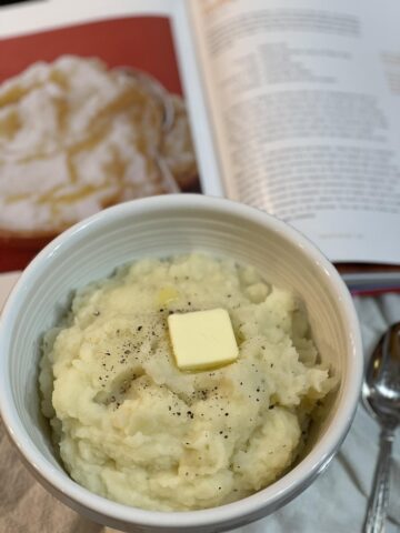 buttermilk mashed potatoes and butter in white bowl