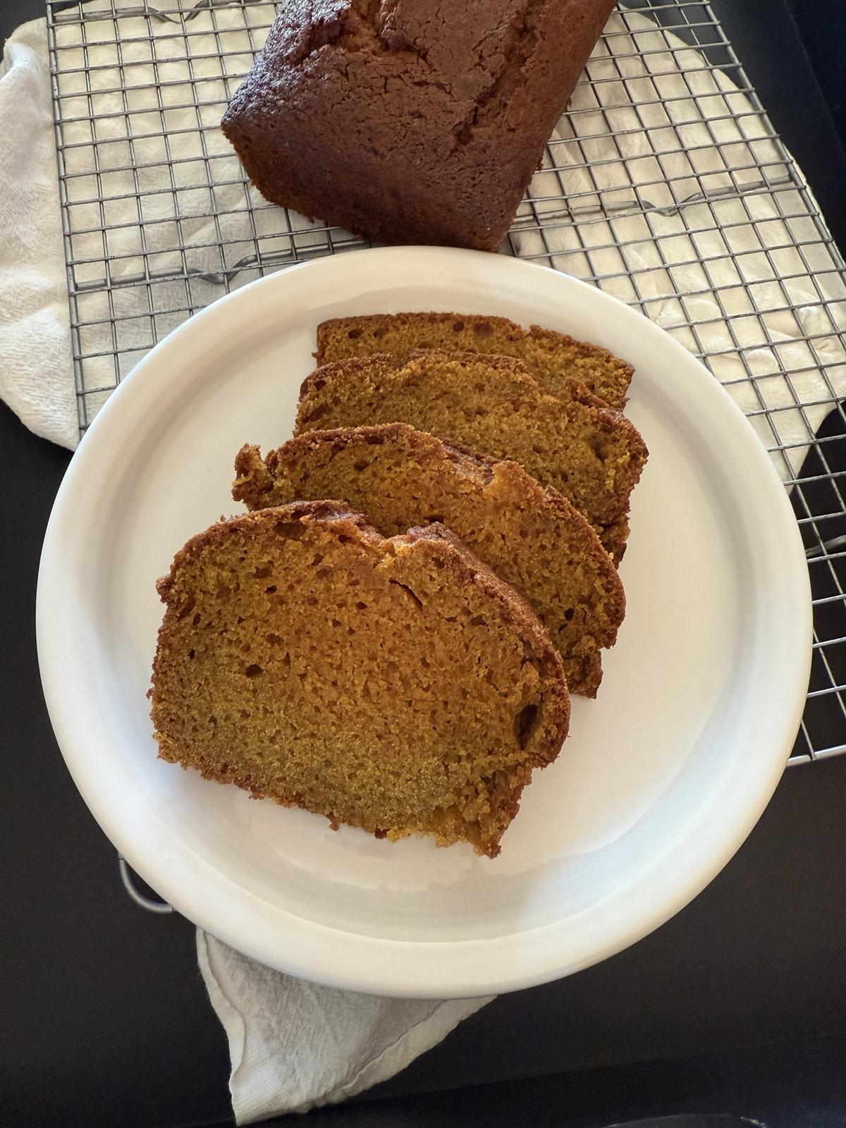 gluten free pumpkin bread on white plate on cooling rack
