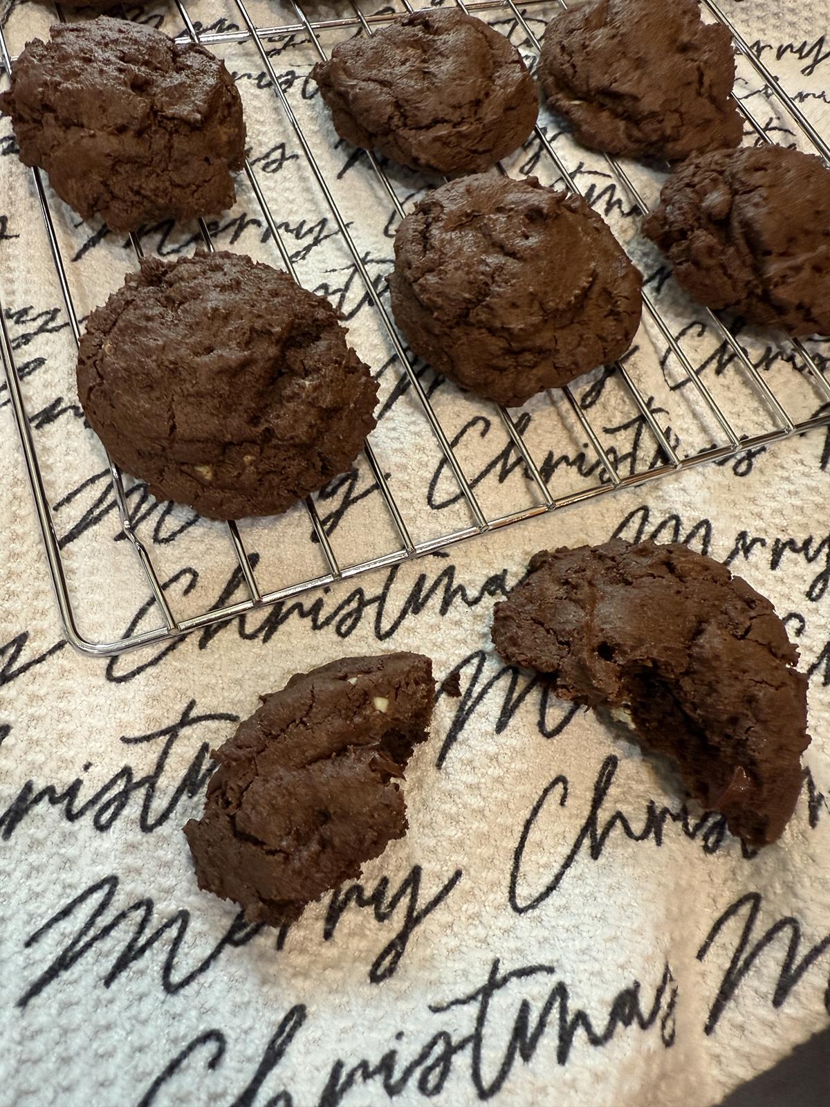 gluten free andes mint cookies on cooling rack with Merry Christmas towel in the background and broken cookie in front