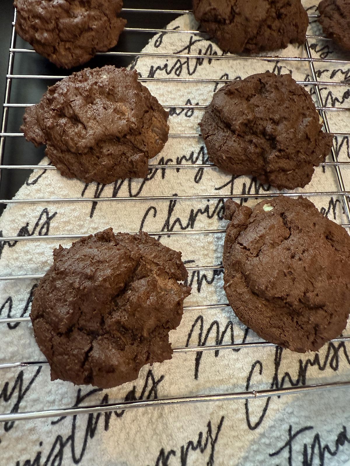 gluten free Andes mint cookies on cooling rack with Merry Christmas towel in the black background