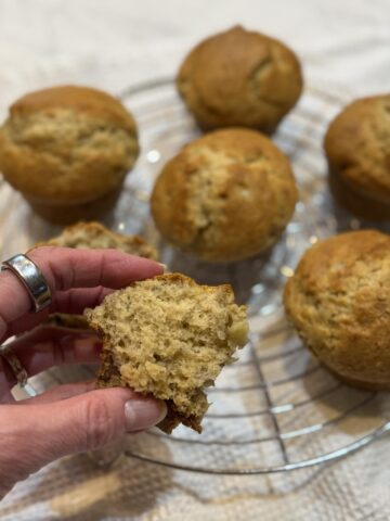 hand holding small batch gluten free muffins on cooling rack