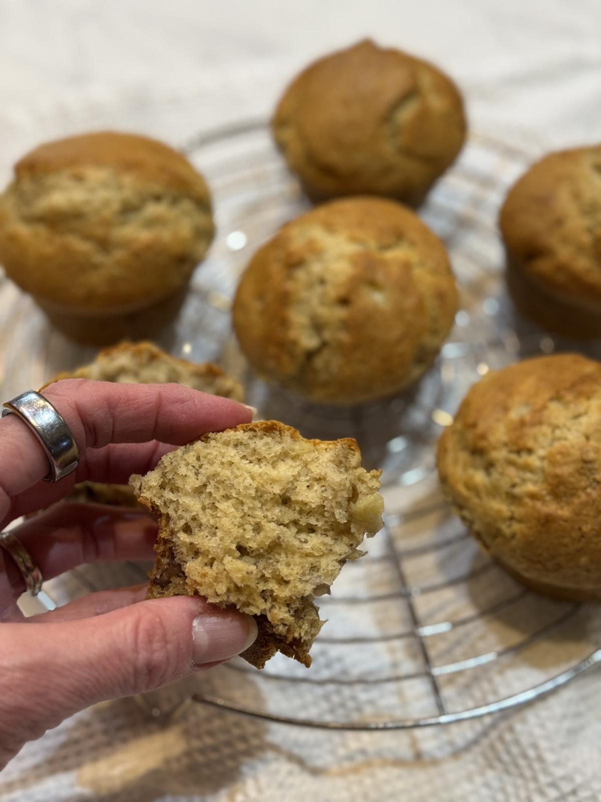 hand holding small batch gluten free muffins on cooling rack