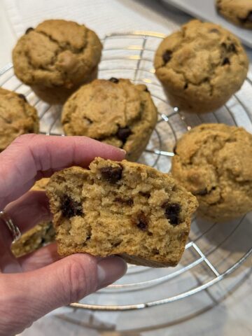 hand holding oatmeal chocolate chip peanut butter muffin