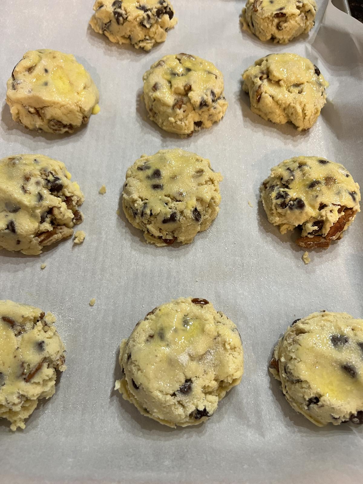 unbaked chocolate chip pecan scones on parchment lined baking sheet