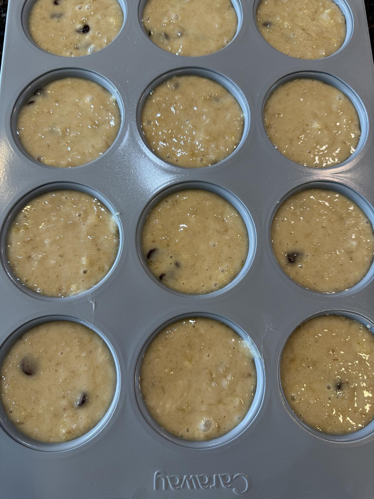 oatmeal banana muffin batter in grey muffin pan