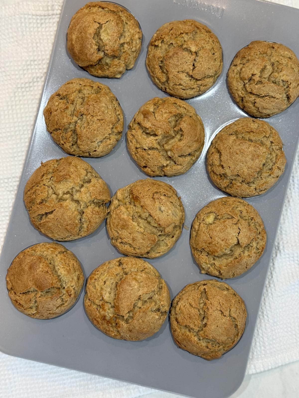 pan of peanut butter banana muffins on white background