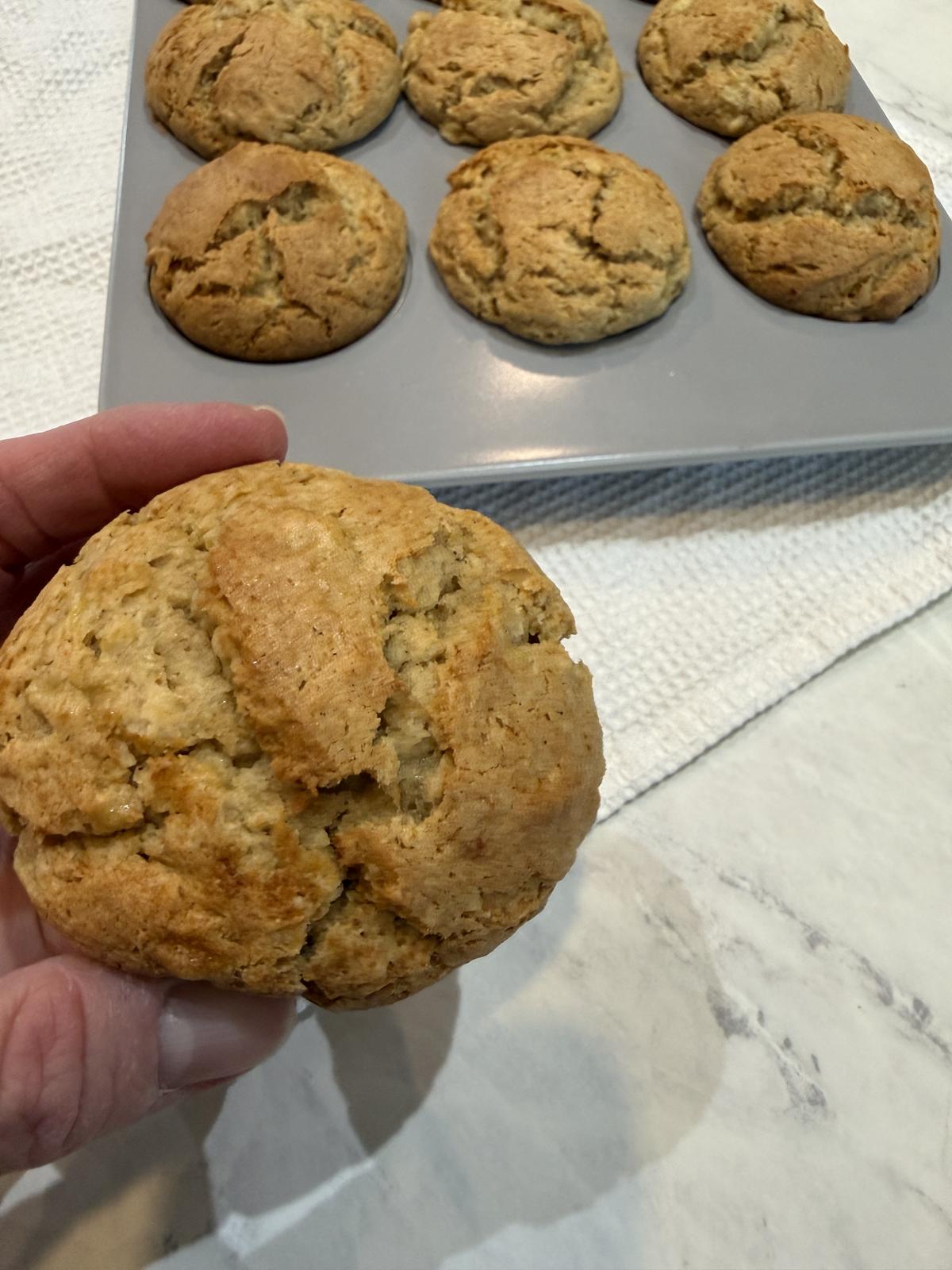 Peanut Butter Banana Muffin with pan of muffins in background