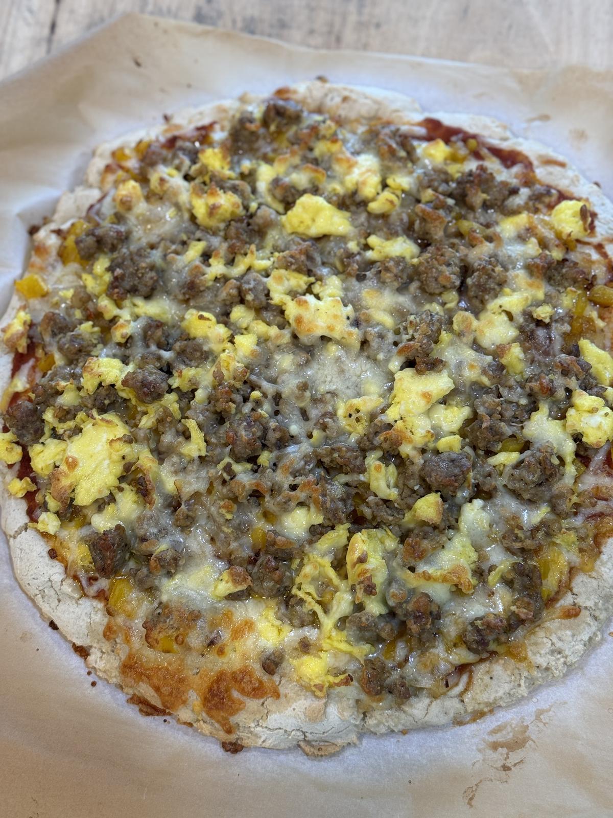 breakfast pizza on parchment paper