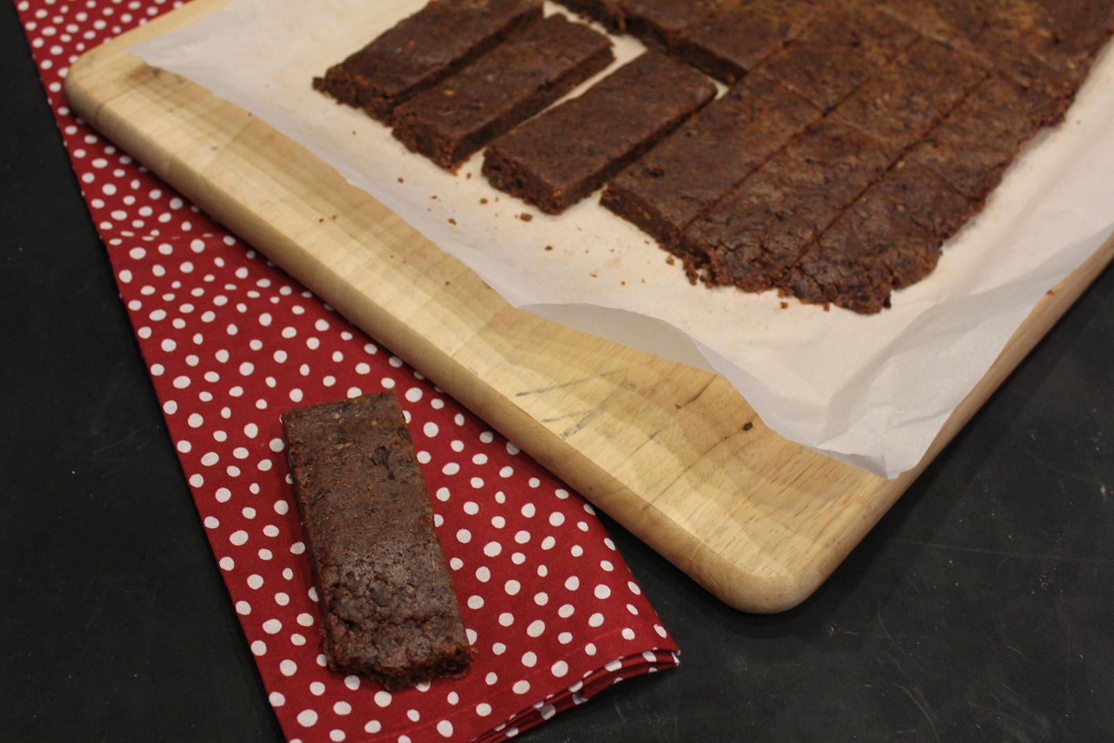 Homemade Nut Free Larabars on red and white napkin with bars on cutting board