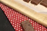 Homemade Nut Free Larabars on red and white napkin with bars on cutting board in background