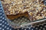 No Bake Peanut Butter Bar in glass pan on black and white table runner