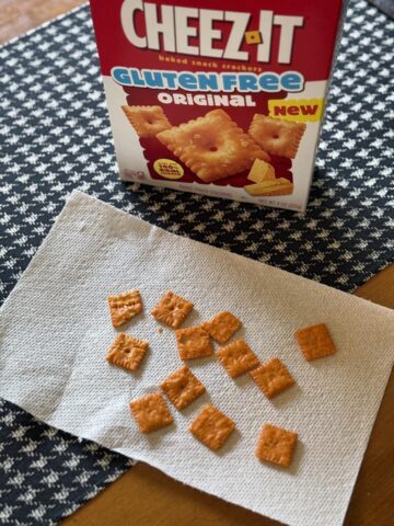 box of gluten free cheez it crackers on table with crackers on napkin