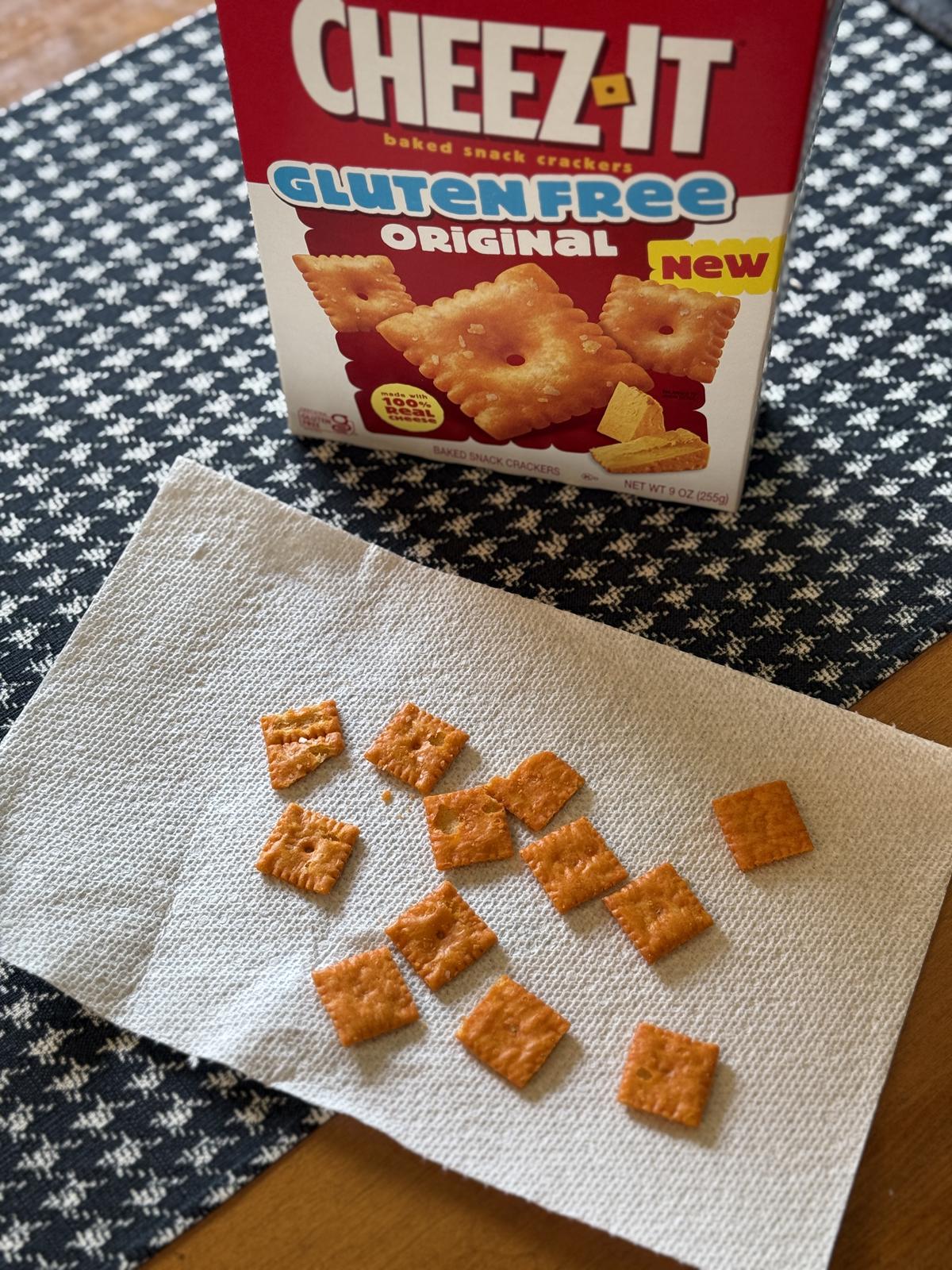 box of gluten free cheez it crackers on table with crackers on napkin