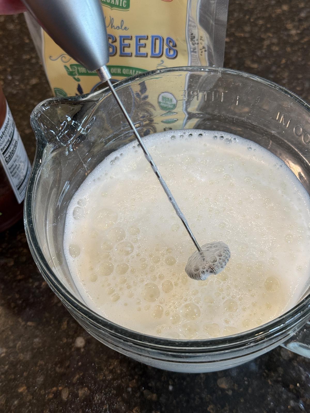 high protein milk with whisk in glass bowl