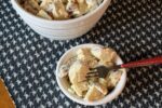 old fashioned potato salad in white bowl with fork