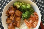 Air Fryer Teriyaki Salmon, rice, broccoli and kimchi in a white bowl