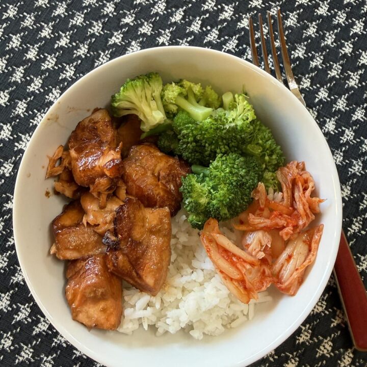 Air Fryer Teriyaki Salmon, rice, broccoli and kimchi in a white bowl