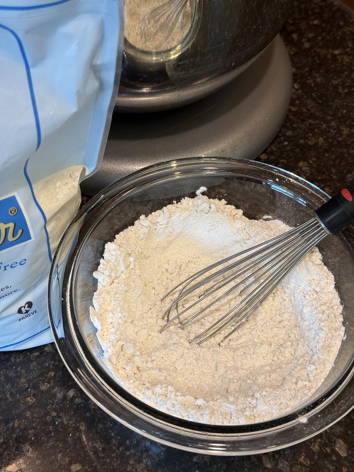 homemade self rising gluten free flour in glass bowl with whisk