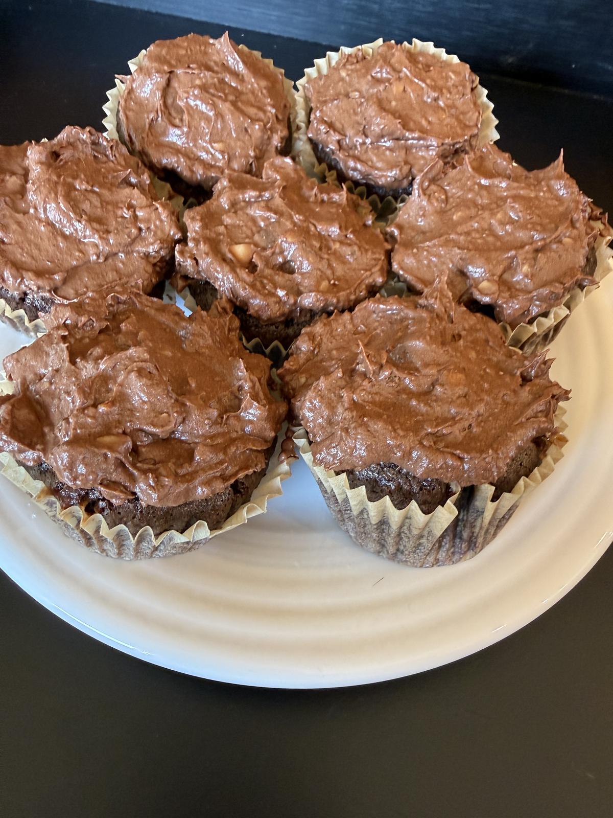 Chocolate Toffee Cupcakes on white plate on black background