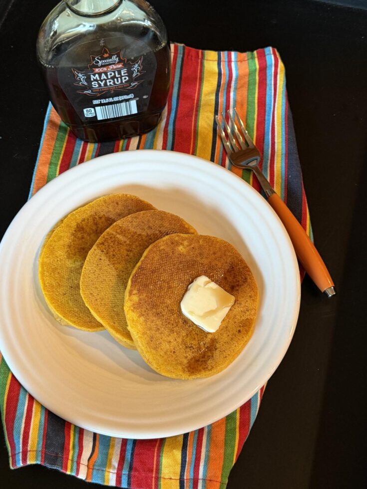 Homemade Gluten Free Ihop Pumpkin Pancakes on white plate and striped napkin